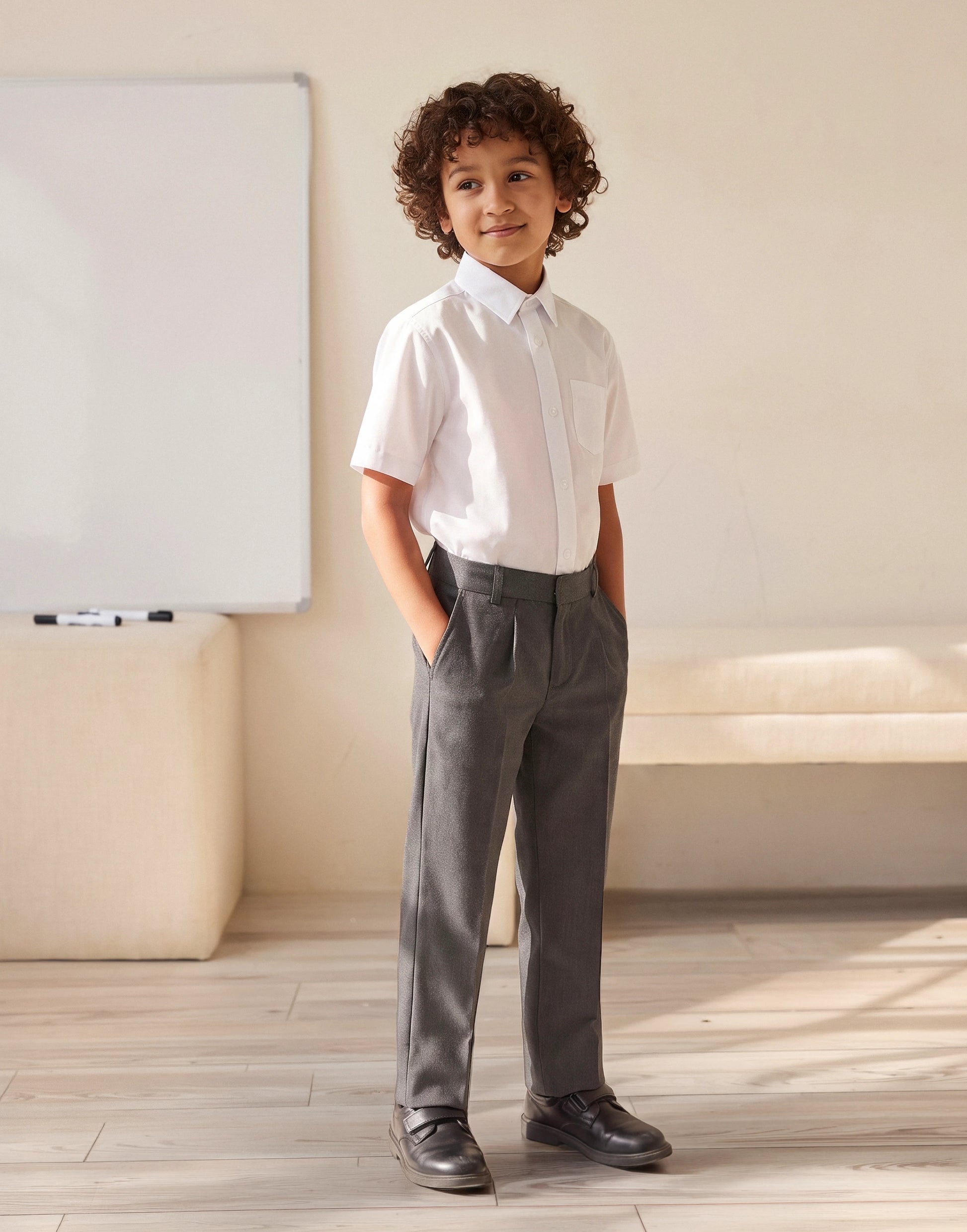 A boy wearing grey 100% GOTS-certified organic cotton school trousers with classic fit side view 