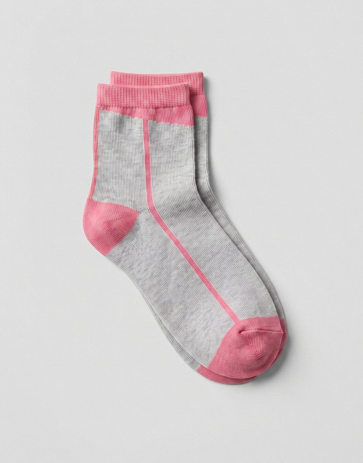 A pair of gray crew socks with pink accents on the toe, heel, and ribbed cuffs, displayed on a light gray background.