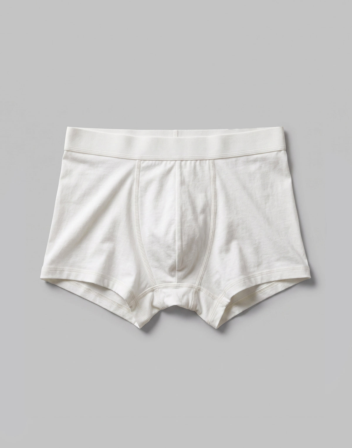 White boys' organic cotton boxer shorts with a soft elasticated waistband.