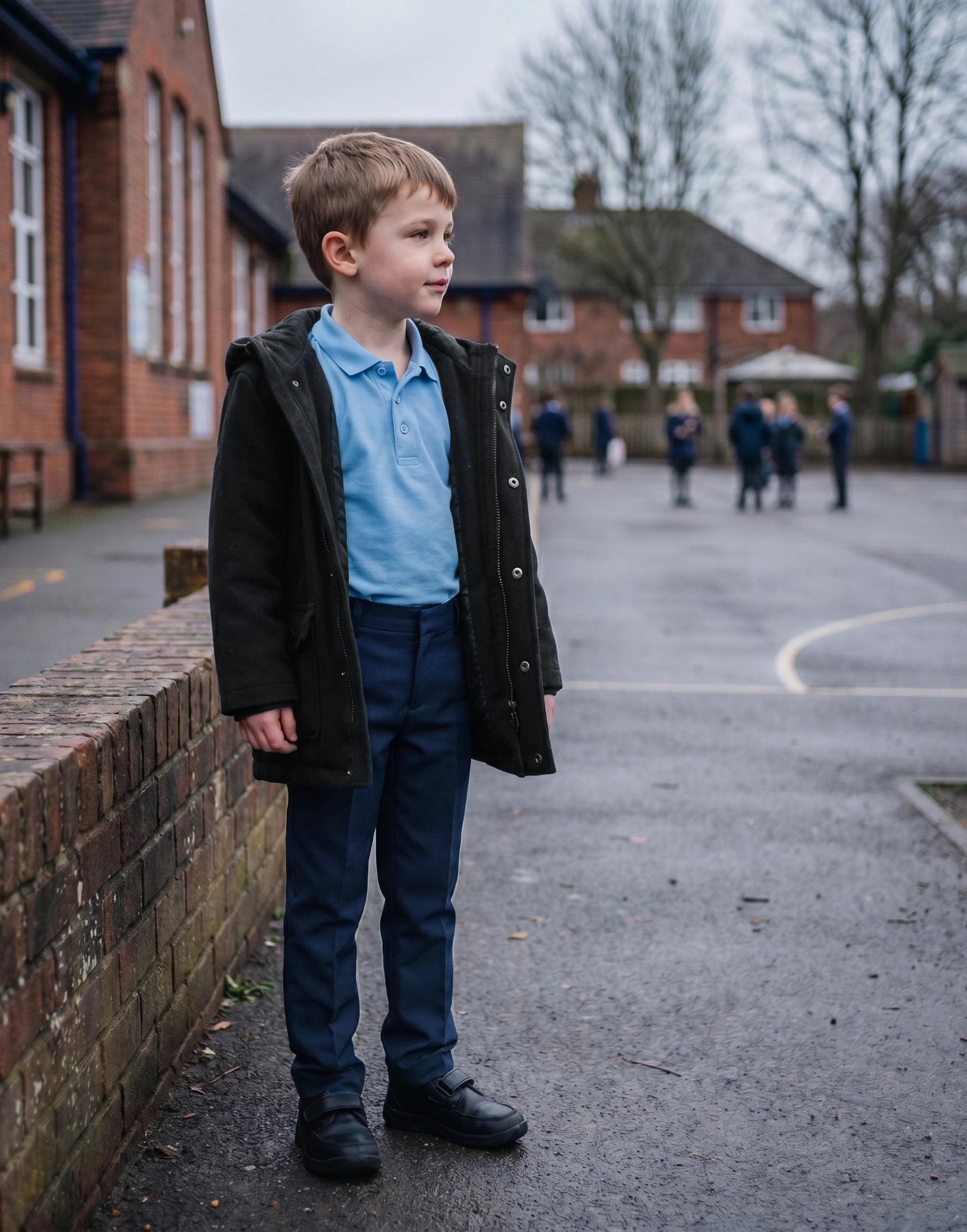 Close-up of navy slim style boys' organic cotton school trousers showing fabric and fit.