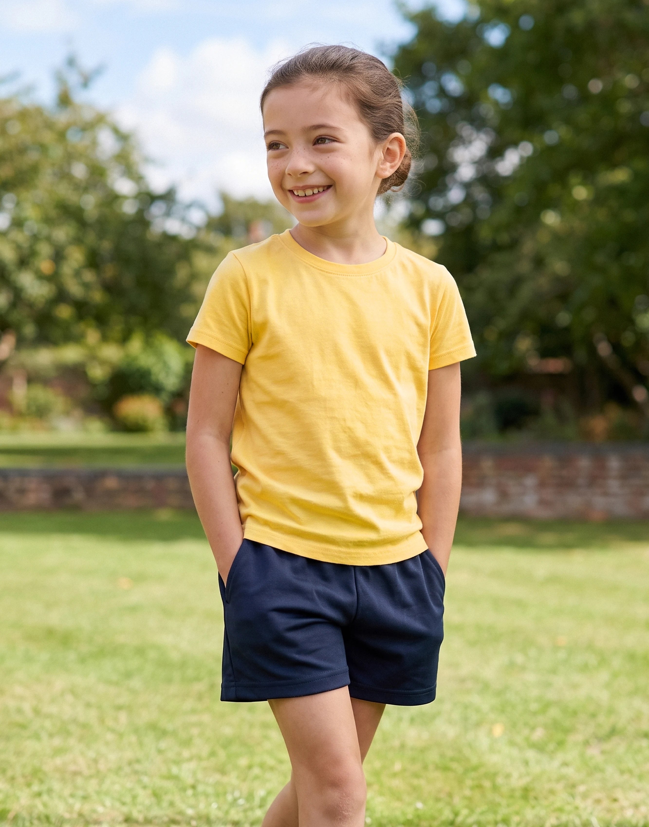 Child wearing a yellow crew neck T-shirt made from 100% GOTS-certified organic cotton, front view.
