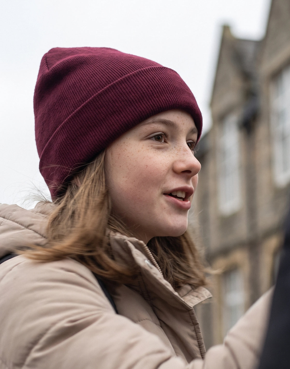 Adult wearing an EcoOutfitters organic cotton cuffed beanie outdoors.