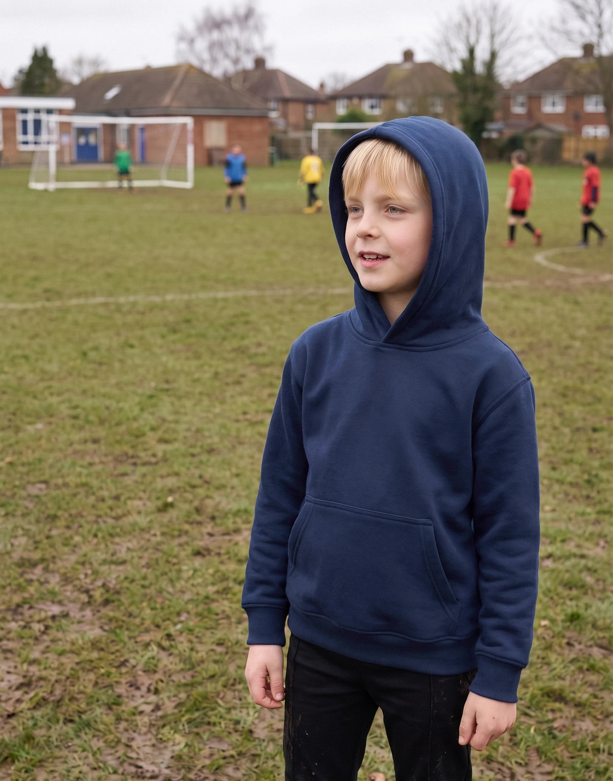 Child wearing a French Navy 100% organic cotton school hoodie with a lined hood and kangaroo pocket, front view.